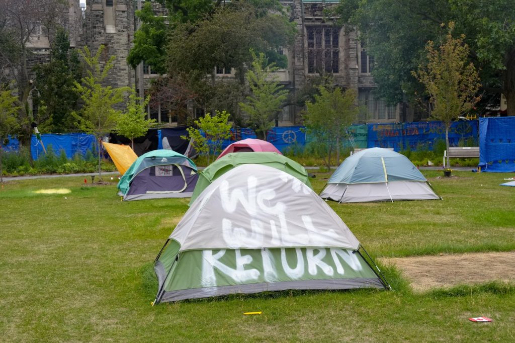 Protesters remove tents from...