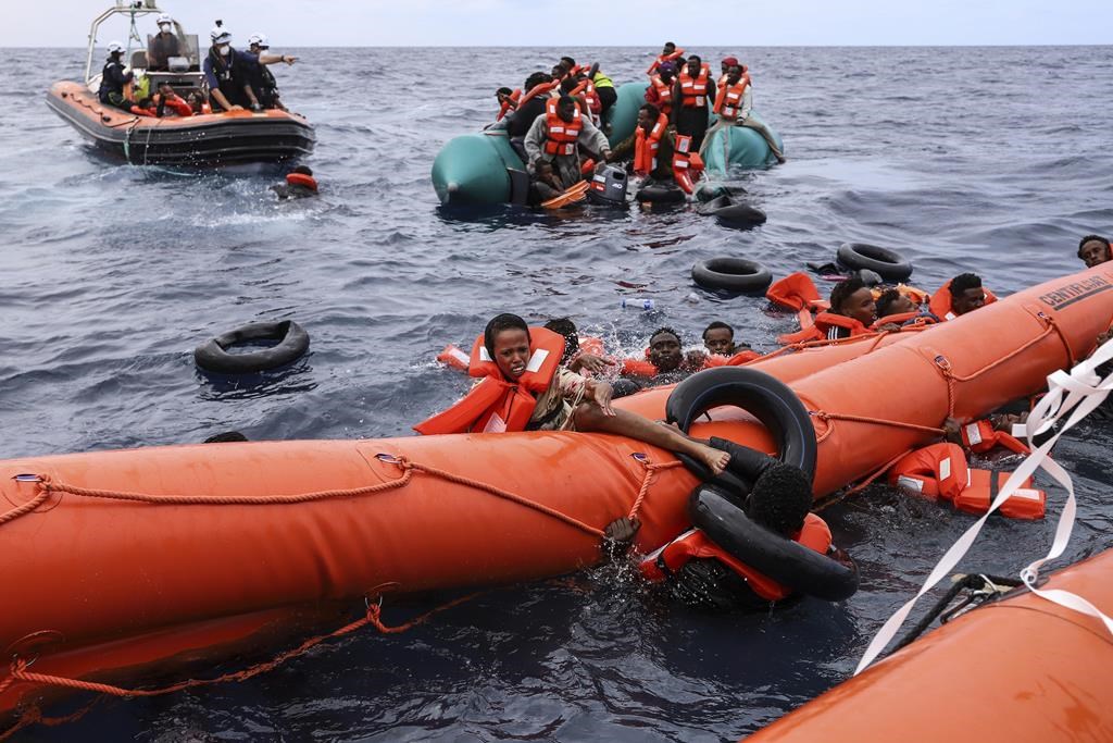 A boat carrying Europe-bound migrants capsizes off Libyan coast, leaving 1 dead and 22 missing